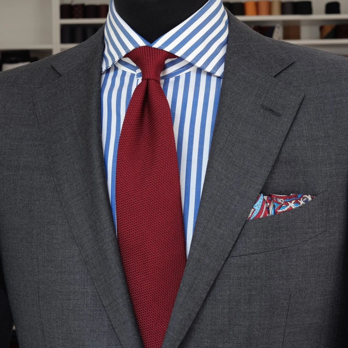 Charcoal grey suit blue bold striped shirt red grenadine tie combination