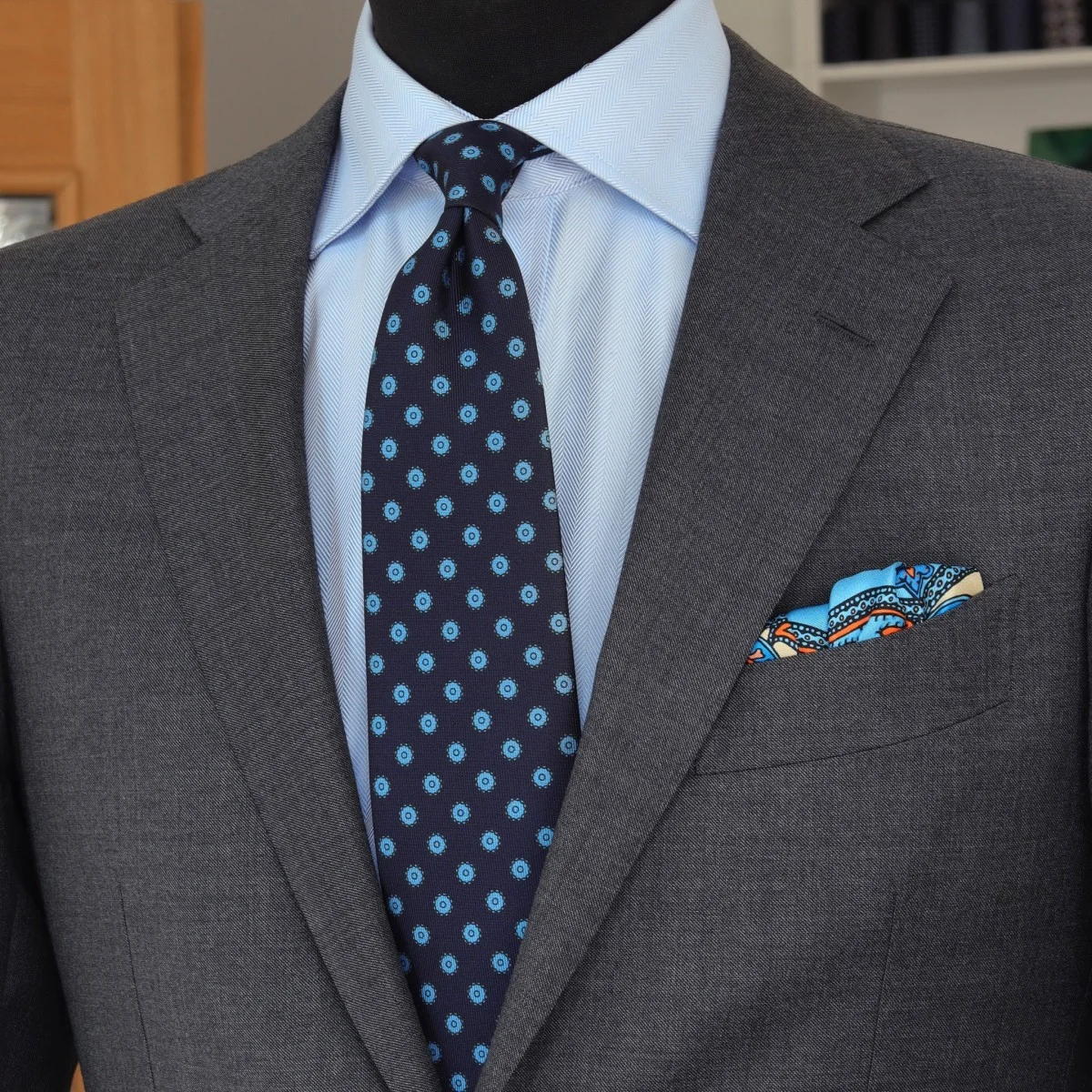 Charcoal grey suit light blue shirt navy patterned knit tie combination