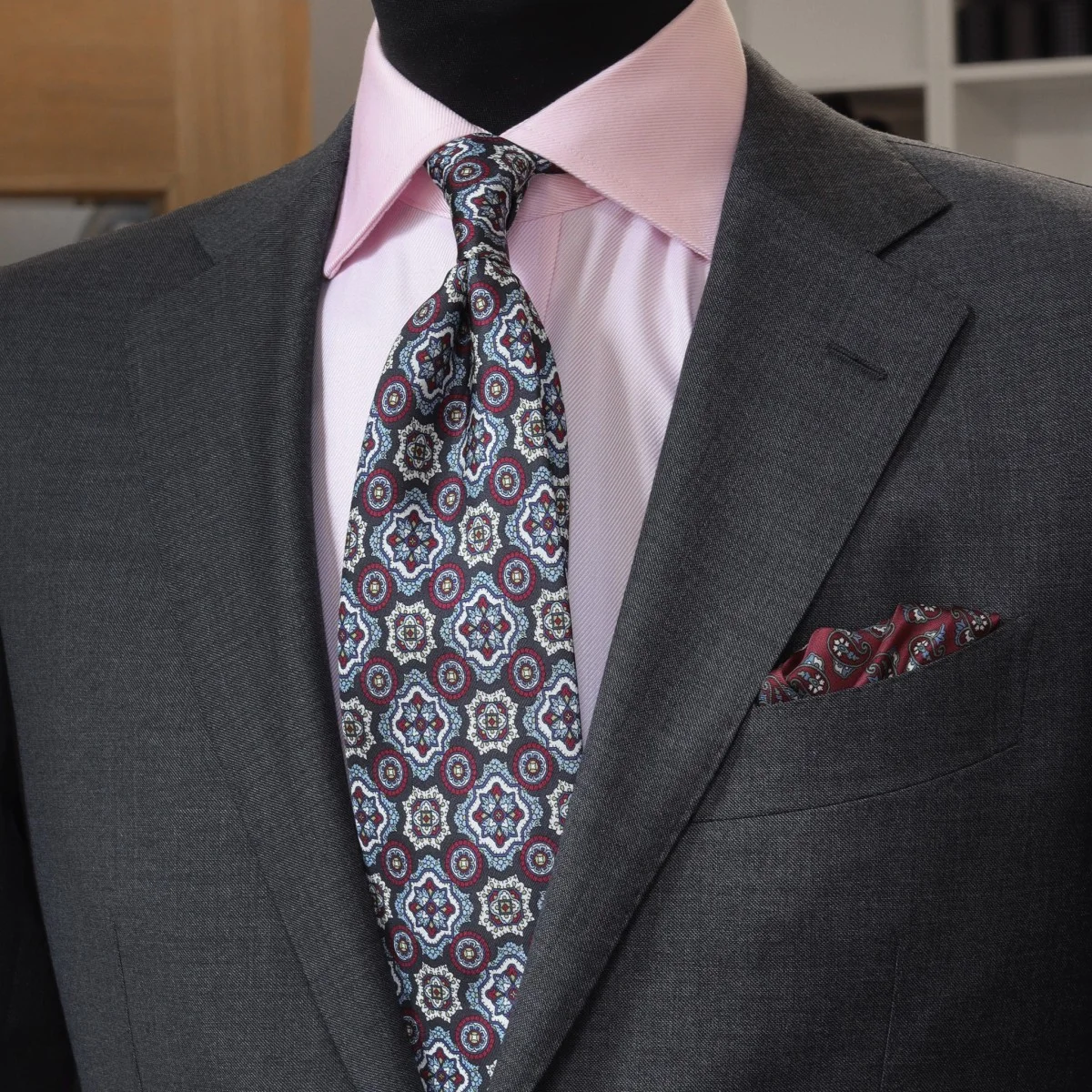 Charcoal grey suit pink shirt patterned tie combination