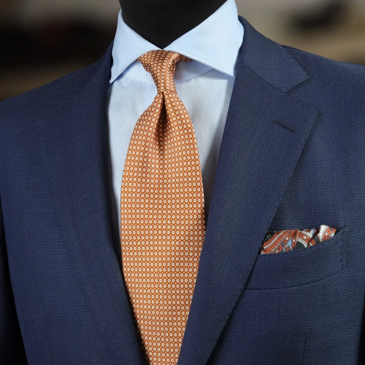 Blue suit, light blue shirt and orange tie combination