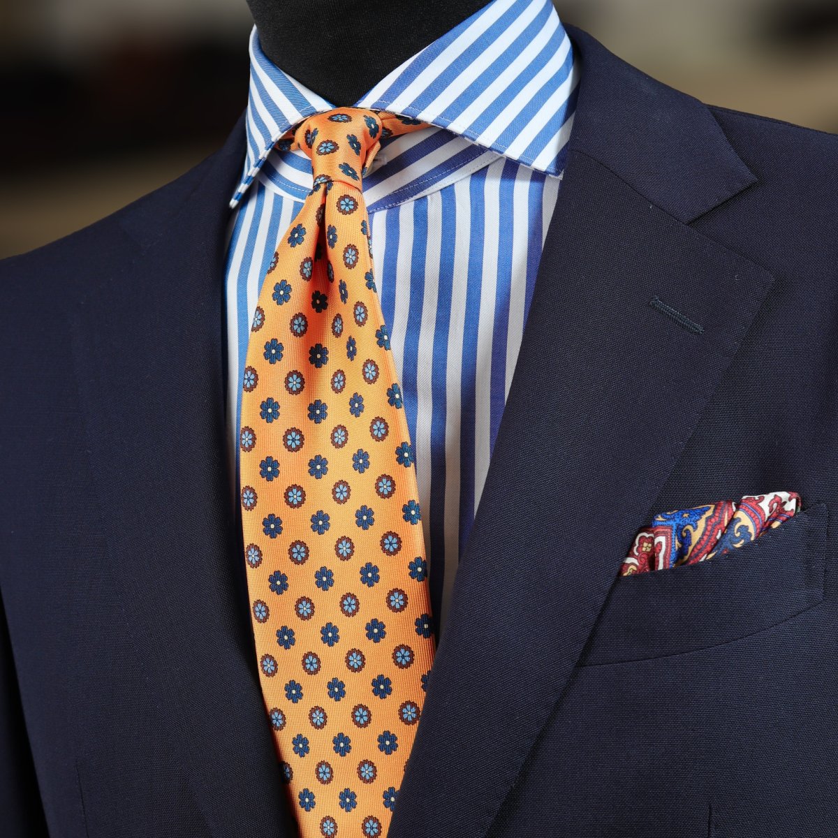 Blue suit, striped blue shirt and yellow tie with floral pattern combination